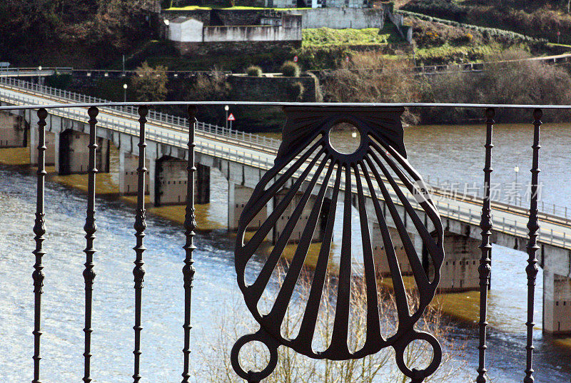 Railing with the shape of a pilgrim scallop, bridge over river Miño.